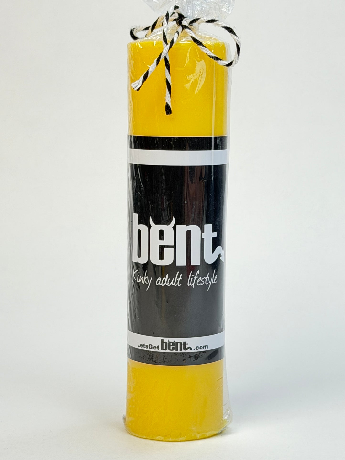 Bent yellow wax play candle with product packaging