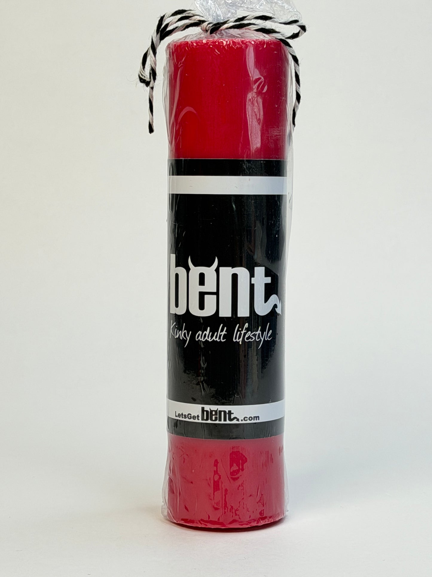 Handmade red paraffin wax play pillar candle by Bent in packaging