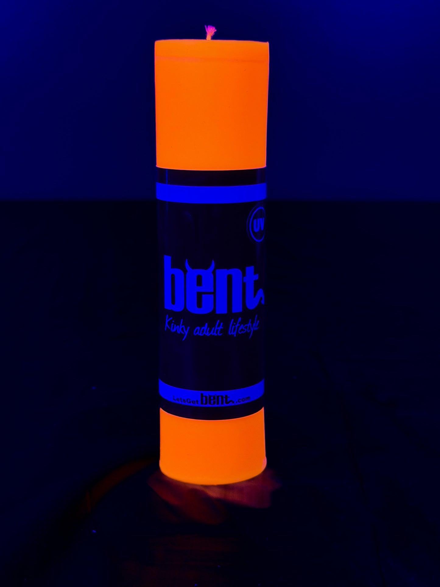 Orange UV candle under blacklight